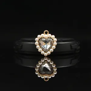 Close-up detail of the 18mm gold alloy heart pendant adorned with pearls and crystal rhinestones.