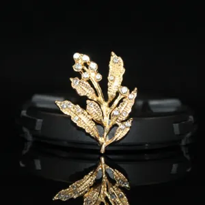 Detailed view of gold alloy leaf branch rhinestone DIY hair accessory for bridal hairpin craft.