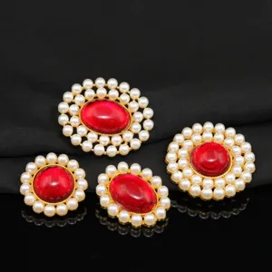 Close-up detail of vintage style alloy red stone and pearl inlay DIY jewelry accessories.