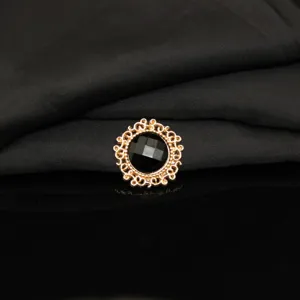 Close up detail of round alloy rhinestone black gemstone flower button for DIY crafts decoration.
