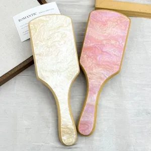 Close-up of marble acetate pattern on bamboo paddle hair brushes for scalp massage