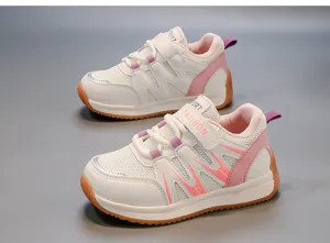 Close-up of breathable pink mesh children's sports shoes with soft sole and strap