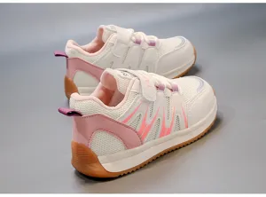 Detailed view of breathable pink and white mesh children's sneakers with gum soles