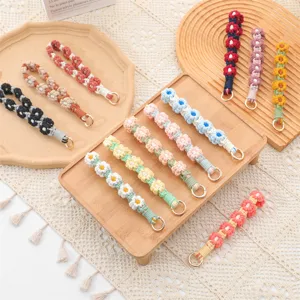 Pulseras de flores de margarita tejidas a mano en colores vibrantes para llaveros