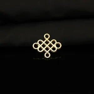 Close-up detail of the vintage gold-colored four-hole mystic knot metal DIY accessory.