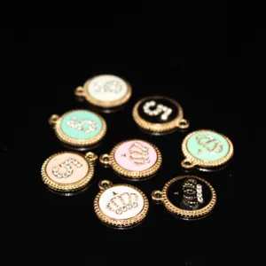 Close-up of zinc alloy crown and number 5 charms, colorful enamel DIY jewelry accessories.