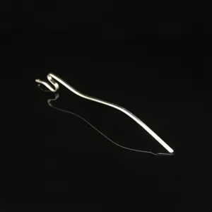 Close-up detail of the metal snake hairpin, highlighting its wavy shape and silver finish.