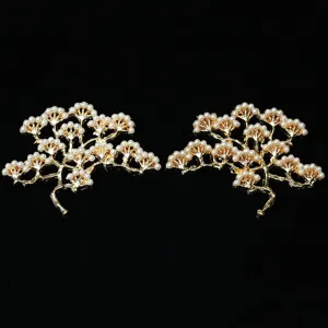 Gold pine tree branch DIY hair accessory detail with white pearls for traditional crafts.