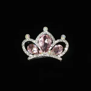 Close-up detail of silver alloy pink rhinestone crown accessory, sparkling crystal.