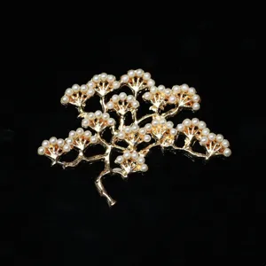 Detailed close-up of gold alloy pine tree branch hairpin accessory adorned with small white pearls.