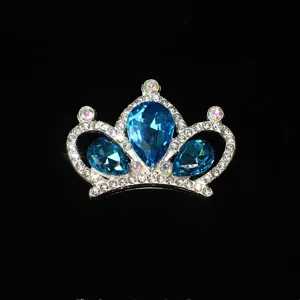 Close-up detail of a sparkling blue crystal crown alloy hair accessory part with clear rhinestones.