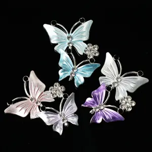 Detailed shot of sparkling rhinestone butterfly and flower alloy DIY charms and accessories.