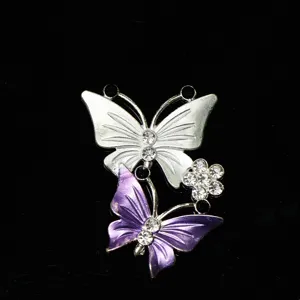 Detailed shot of sparkling rhinestone painted butterfly DIY accessory for phone case or shoes.