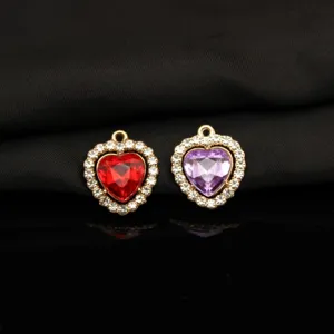 Close-up detail of colorful heart crystal rhinestone alloy pendant jewelry making accessory.