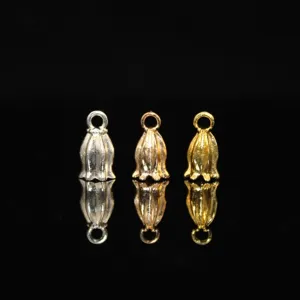 Close-up detail view of bell flower metal cap pendants in silver, gold, and rose gold finishes.