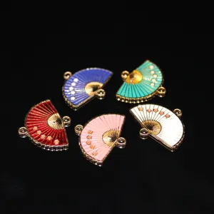 Enamel fan shaped alloy charms with plum blossom details, close up view for DIY jewelry making.