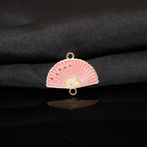 Close-up detail of pink enamel plum blossom folding fan alloy charm with dual hanging loops.