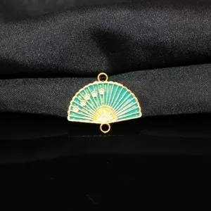 Close-up detail of Chinese style teal enamel fan metal alloy pendant charm with plum blossom.