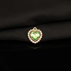 Close-up detail of a charming green heart rhinestone alloy pendant charm for DIY jewelry making.