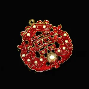 Red and gold alloy double happiness hair accessory component, traditional style close-up detail.