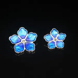 Detail view of blue five-petal flower alloy dripping oil DIY jewelry making accessory.