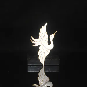 Close-up detail of traditional Chinese style white and gold crane hairpin accessory.