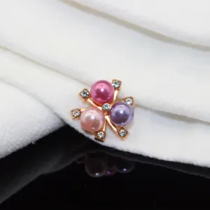 Close-up detail of DIY alloy hair accessory component with three colorful pearls.