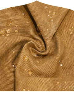 Waterproof brown canvas fabric detail close-up, durable textile material for camera bag.