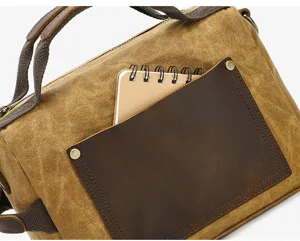 Retro waxed canvas handbag detail view, featuring durable leather trim and vintage canvas.