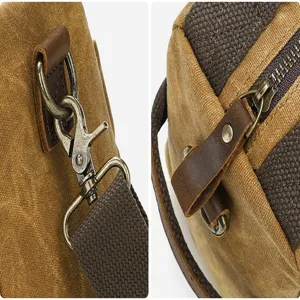 Close up detail of vintage waxed canvas messenger bag hardware, bronze metal hooks and zippers.