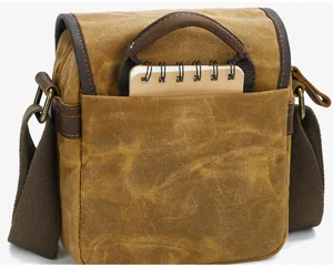 Vintage canvas DSLR camera shoulder bag with brown leather trim and adjustable crossbody strap.