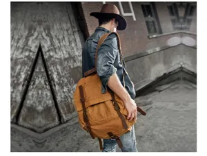 Vintage canvas backpack for men, casual large capacity rucksack for travel and outdoor use.