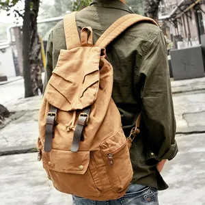 Vintage brown canvas backpack for students, casual travel rucksack with large capacity design.