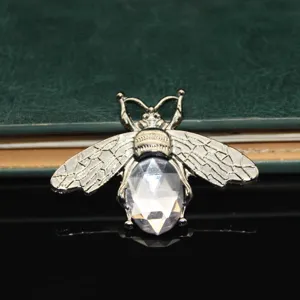 Detailed close-up shot of a crystal rhinestone bee charm for DIY crafts and phone cases.