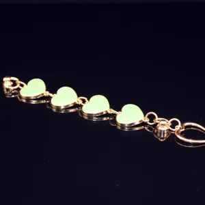 Close-up detail of gold alloy chain with light green oil-drop heart charms for DIY phone case decor.