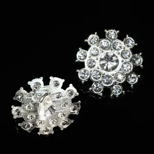 Dettaglio ravvicinato di bottoni con gambo in metallo e strass scintillanti per cappotti.