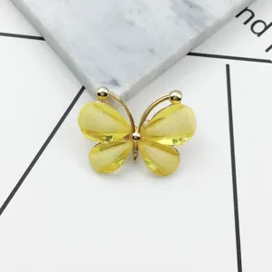 Crystal butterfly alloy accessory detail shot, sparkling yellow DIY phone case decoration.