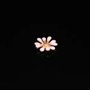 Closeup of enamel daisy flower alloy charm, perfect for DIY phone case and accessories.