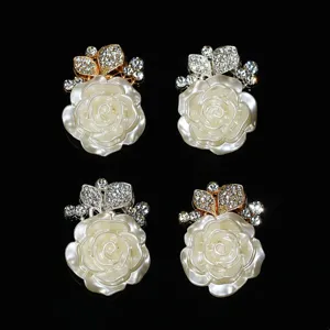 Close-up detail shot of alloy rhinestone rose flower buttons for DIY phone case decoration.