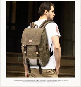 Detailed view of the vintage canvas camera backpack worn by a model outdoors, rugged style.