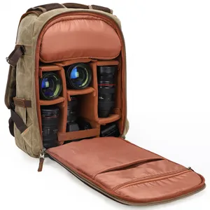 Vintage canvas camera backpack with padded dividers for DSLR cameras and multiple lenses.