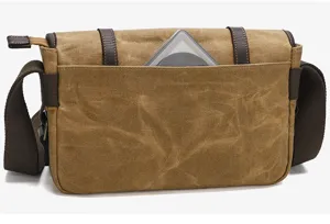 Canvas messenger camera bag detail showing durable brown fabric and front storage pocket.