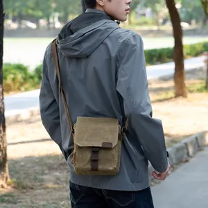 Vue de détail extérieure d'un sac bandoulière appareil photo en toile durable pour homme.