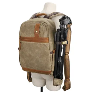 Waterproof waxed canvas camera backpack with tripod holder, vintage outdoor DSLR photography bag.