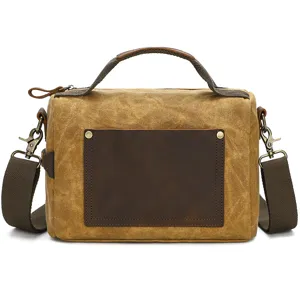 Men's vintage waxed canvas shoulder messenger bag with top handle and leather pocket.