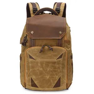 Vintage canvas leather backpack for outdoor travel, DSLR camera and laptop storage.