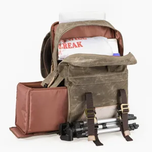 Vintage canvas camera backpack with removable insert and tripod straps for DSLR photography.