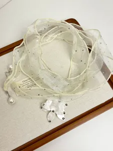 Elegant sheer chiffon ribbon necklace with pearls and a sparkling flower pendant.