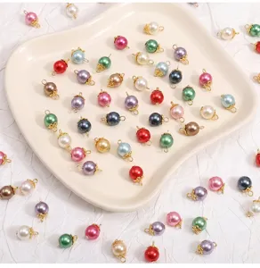 Glass imitation shell pearl round bead pendants with gold caps for DIY jewelry making.