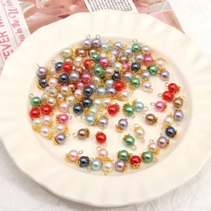 Colorful glass imitation pearl charms with gold loops for DIY handmade jewelry crafting.